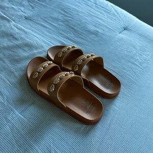 Brown sandals with puka shells on straps